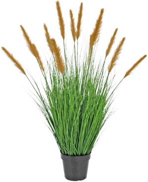 La planta de césped artificial Avestruz 100 cm retardante de fuego se encuentra en una maceta negra con hojas altas parecidas a la hierba y largas plumas marrones, que añaden una decoración verde sobre un fondo blanco liso.