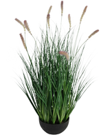 El bonsái de hierba de cebolla de oruga de césped artificial es una planta de césped artificial ignífugo de 70 cm de altura con delgadas hojas verdes y espigas de flores de color marrón claro en una maceta redonda negra, perfecta para un interior elegante.