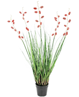 De Kunst Grasplant Duizendpootgras 100 cm brandvertragend is een zwarte kunstplant in pot met hoge, dunne groene bladeren en lange stelen met trossen kleine, ovale roze-rode bloemen in een rechtopstaande, spreidende display.